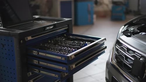 Car Service Automobile Engine Maintenance Tools Near Open Hood at the Technical Site Closeup