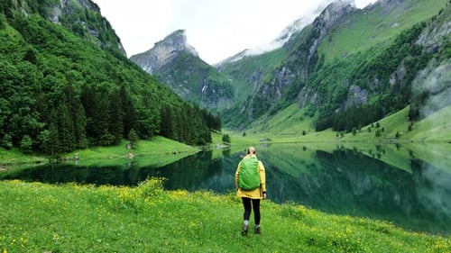 A Beautiful and Serene Mountain Landscape Featuring a Hiker Exploring the Great Outdoors