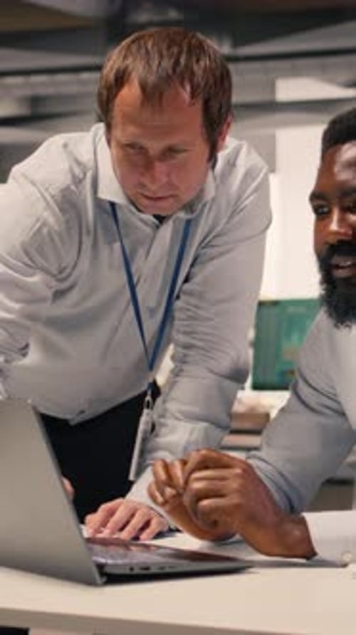 Men Work on Laptop in Tech Office