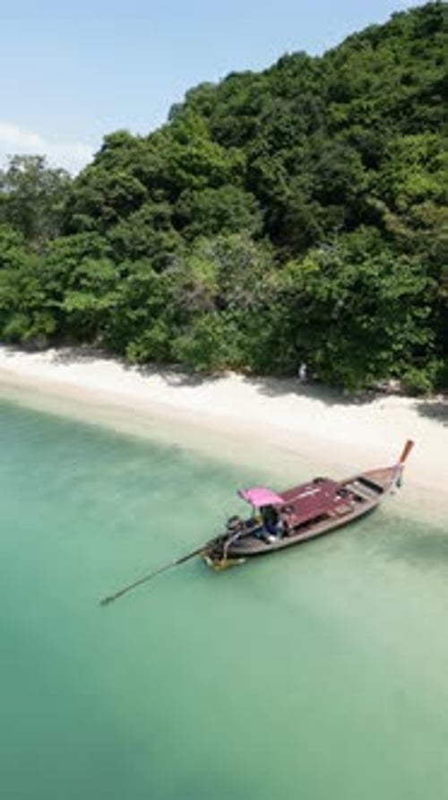 Vertical Video Drone Shot Above a Sailboat Exploring a Tropical Coastal Bay