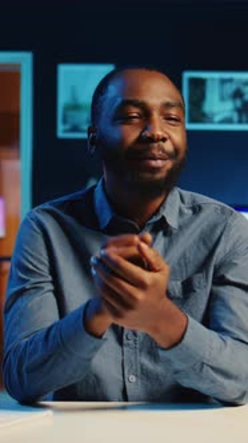 Young Adult Speaking From Desk At Night