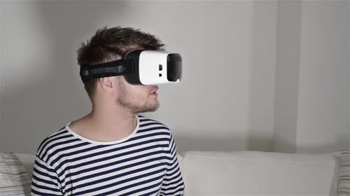 Man Using Virtual Reality Headset in Living Room