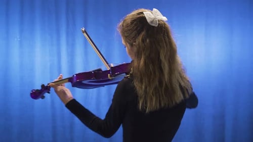 Woman Plays Purple Violin with Blue Backdrop