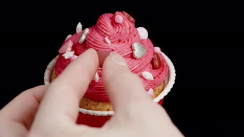 Decorating a Cupcake with Heart Shaped Sprinkles