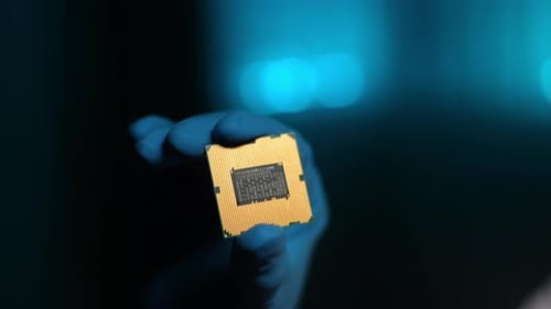 Closeup Presentation of New Semiconductor Microchip Closeup Gloved Hands of Unrecognizable