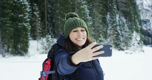 Woman Taking Selfie in Snowy Winter Forest
