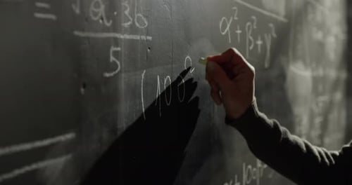 Close Up on the Hand of a Female University Teacher Writing a Mathematics Form