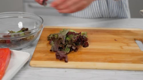 Close Up Of Lettuce Being Chopped For Salad