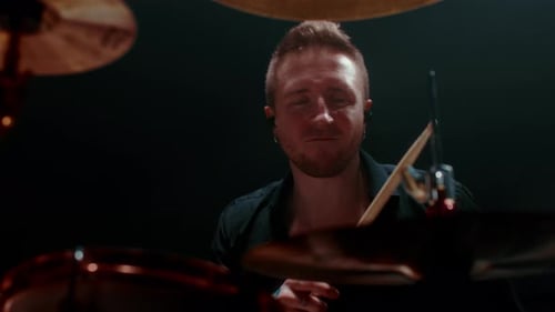 Portrait of Cool Drummer Playing Rock Handsome Man Beating Rhythm By Drumsticks Medium Shot with