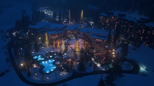 Aerial Drone Shot of Mountain Ski Hotel at Winter Evening