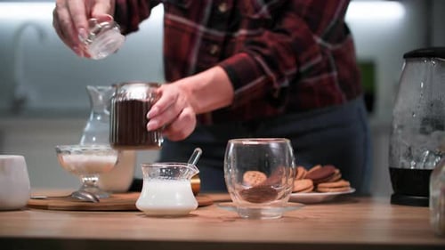 Woman Prepares Coffee Drink in Modern Kitchen
