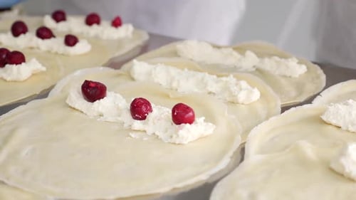 Chef hands placing cherry on delicious dessert crepes