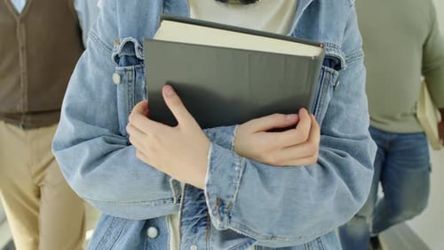 Unrecognizable Students With Textbooks