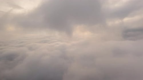 Drone flight over the clouds during sunrise. Golden hour,