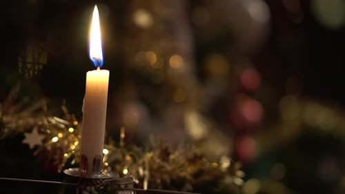 Christmas Candle Burning Near Holiday Decorations