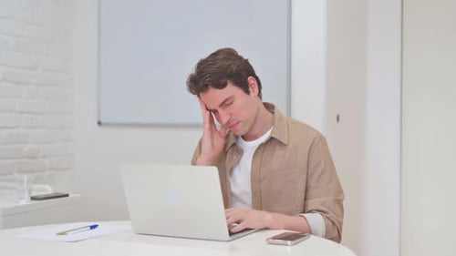 Adult Male Working on Laptop with Headache