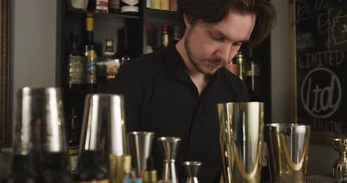 Concentrated Bartender Making Cocktail at Elegant Bar