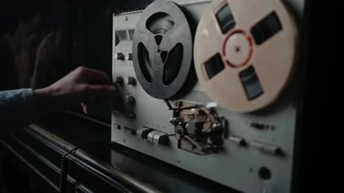Vintage Reel-to-Reel Tape Recorder Being Operated