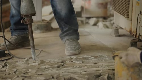 Workers Break up Concrete with Jackhammer