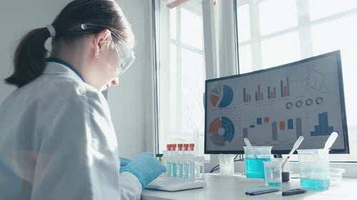 Woman Scientist Working at Computer in a Lab