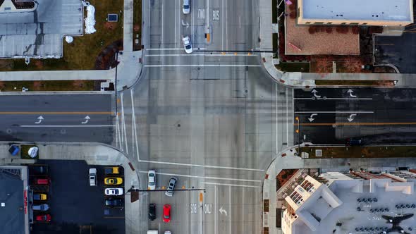 Bird's eye aerial drone top view of a busy intersection with cars ...