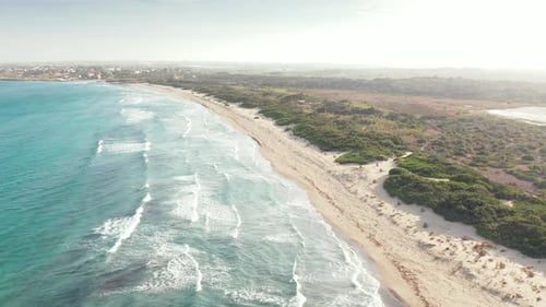 Crystal Blue Sea With Waves Splashing Onto Fine Sandy Beach In The Vendicari Nature Reserve, Sicily,