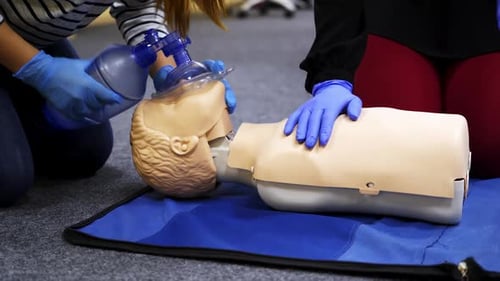 Training compression on a dummy. CPR exercise on a mannequin in the medical center.