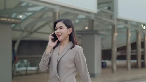 A young beautiful businesswoman is using Smart phone in Modern city