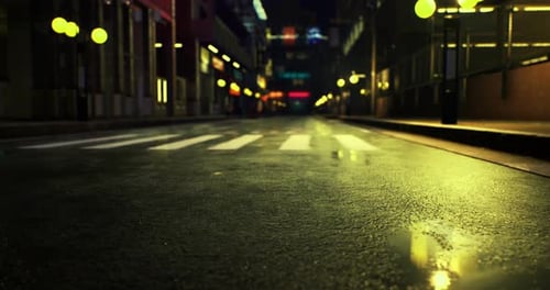 Quiet Urban Street at Night Illuminated By Soft Yellow Lights After Rain