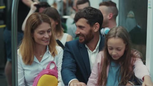 Family on subway with sleeping child in city