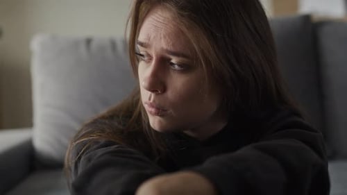 Young Adult Woman with Serious Expression Indoors