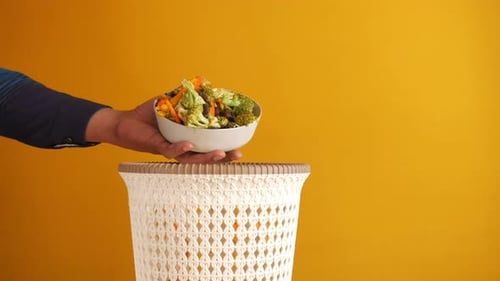 Throwing Vegetables in a Garbage Bin