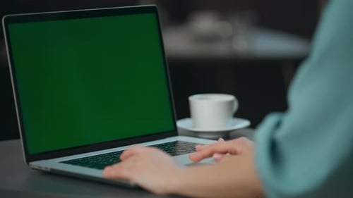 Unknown director typing on computer mockup in modern office green screen laptop