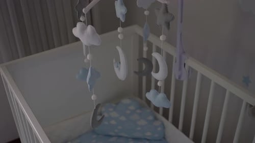 Crib With a Mobile Inside Nursery