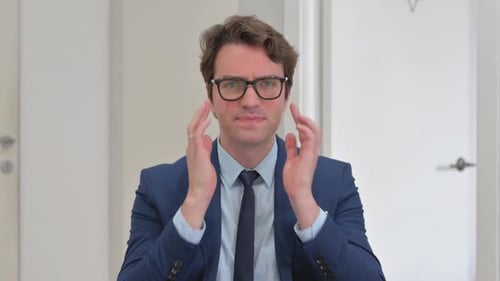 Man in Suit Massaging Temples with a Headache