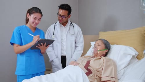 Doctor and Nurse Attend to Senior Patient in Hospital