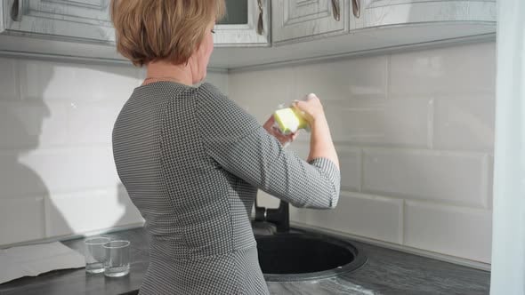 Side View Woman Pressing Sponge Foam Inside Glass Cup in Kitchen ...