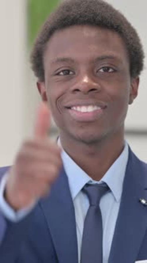 Man in Suit Giving Thumbs Up Approval