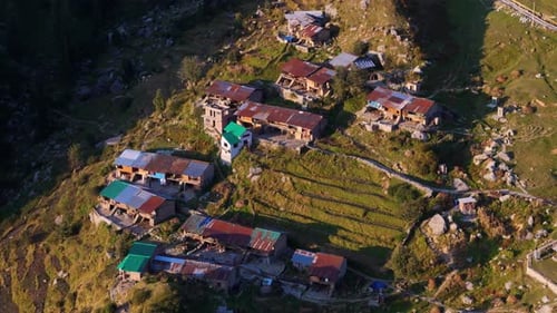Drohnenaufnahme eines kleinen Dorfes in den Bergen, aufgenommen bei Sonnenuntergang