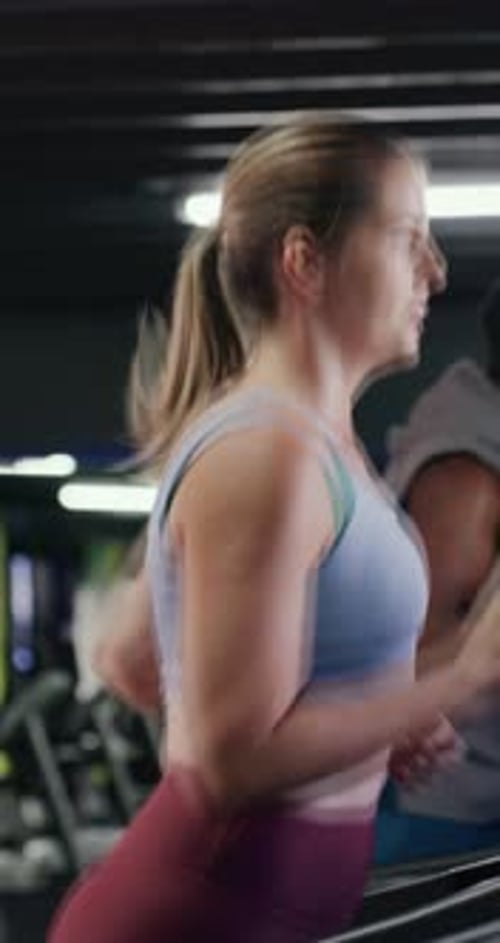 Woman, running and treadmill with exercise at gym, endurance or speed training at wellness class