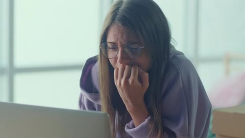 Anxious Sad Woman Looking at Laptop Feeling Frustrated of Bad News