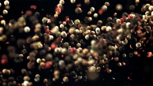 Peppercorns Floating Upwards on Black Background