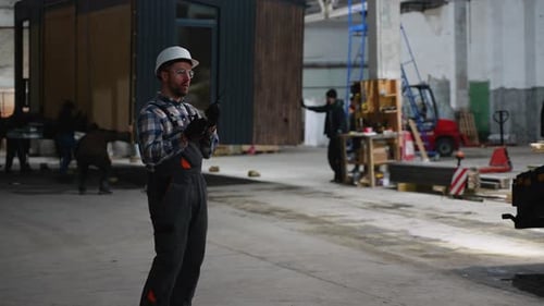 Supervisor Directing Modular Home Transport in Factory
