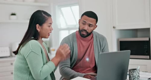 Young Woman and Man Discussing Something on Laptop