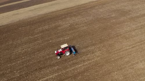 Spring Agricultural Field Work, Tractor With Seeder Sow Seeds in Ground Aerial Slow Motion