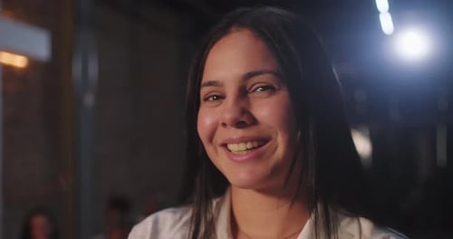Young Woman Smiling at the Camera at Night