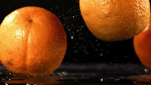 Orange Fall on the Table Filmed is Slow Motion 1000 Fps