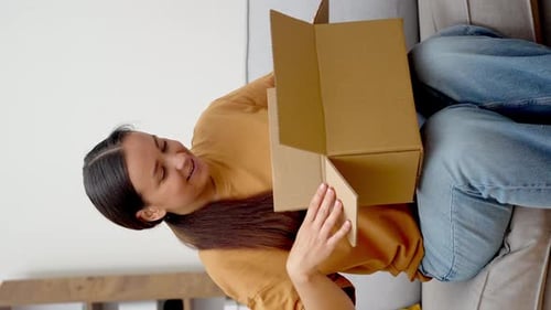 Woman Unboxes New White Headphones at Home