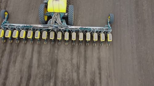 Blue tractor OA working on the field in Ukraine