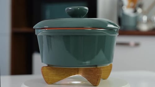 Ceramic Pan on Handmade Wooden Stand Rotate in a Kitchen